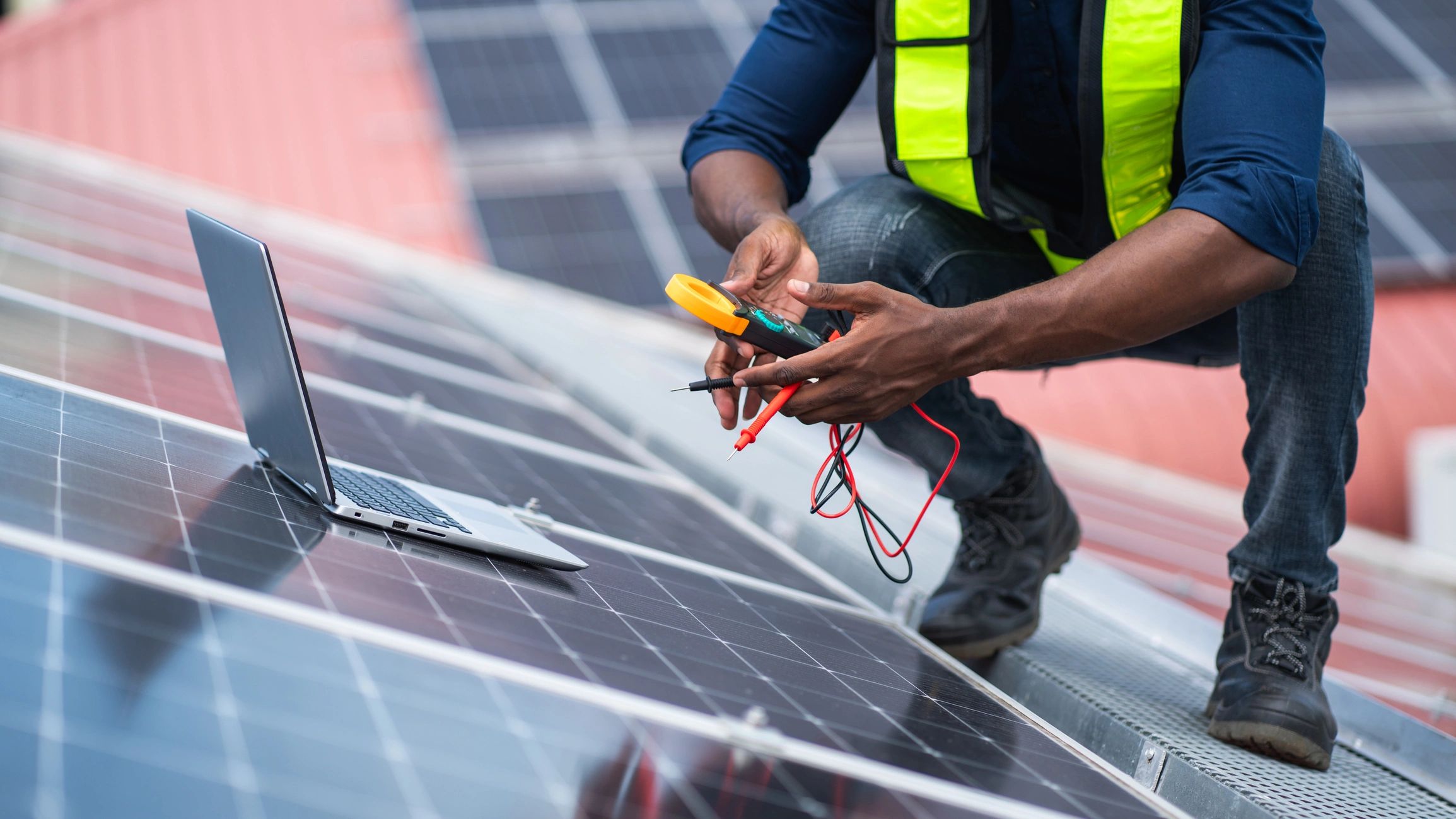 Technician inspecting rooftop solar panels on a California home