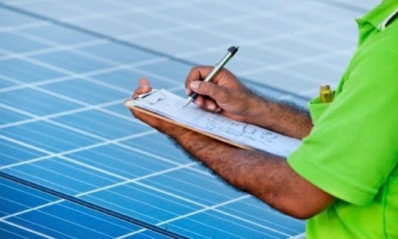 Solar technician working carefully on a residential rooftop